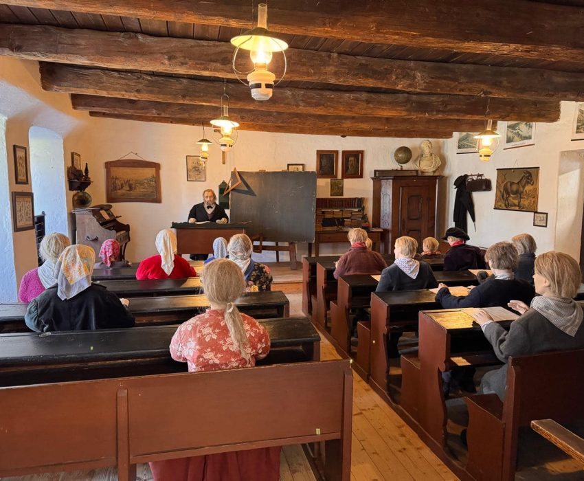 Visitors inside a reconstructed historical school