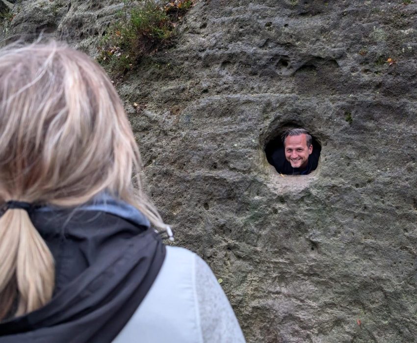 Face peeking through rock hole in Bohemian Switzerland
